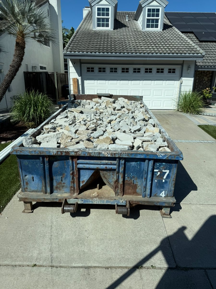 Roll-off container staged for pickup, return, or swap